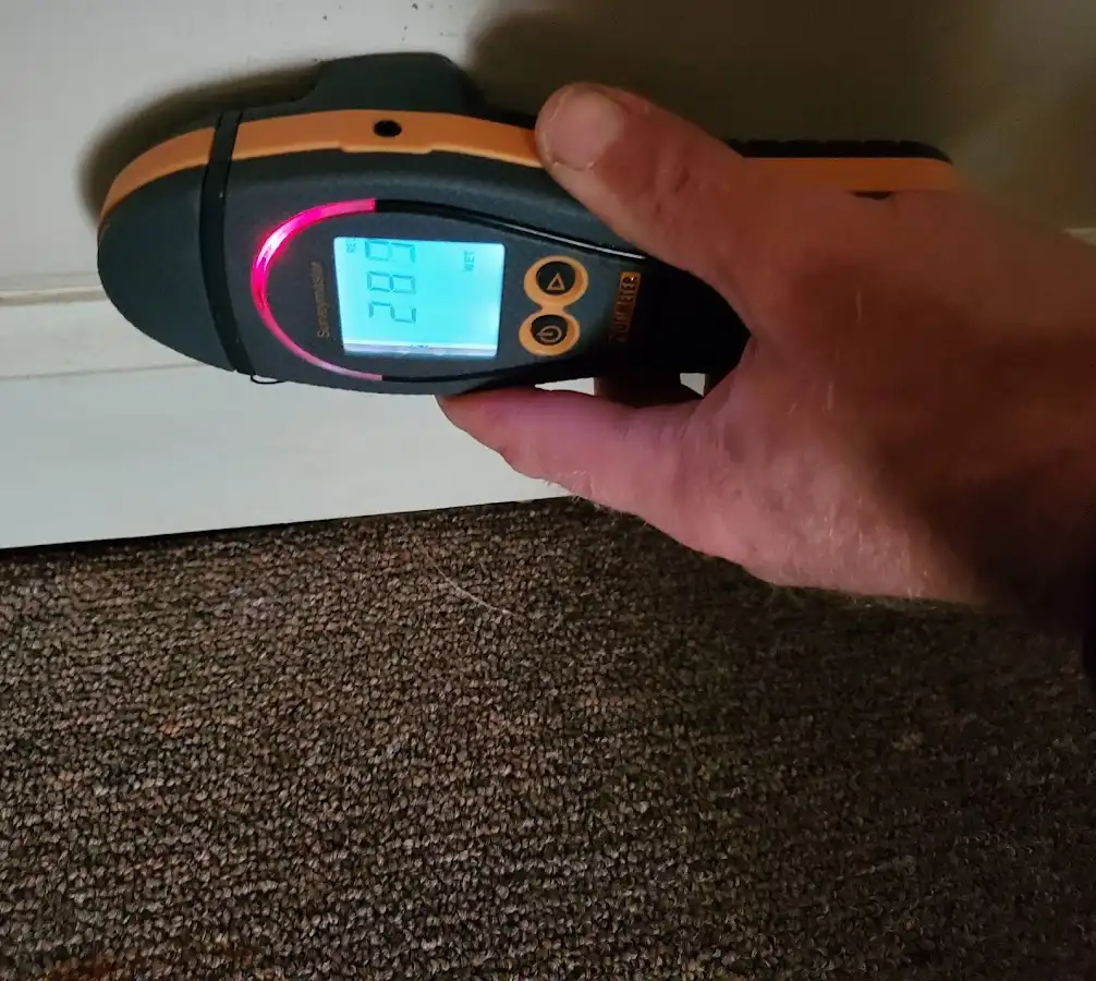 Moisture detection at baseboard during Storm Damage Restoration in DuPont